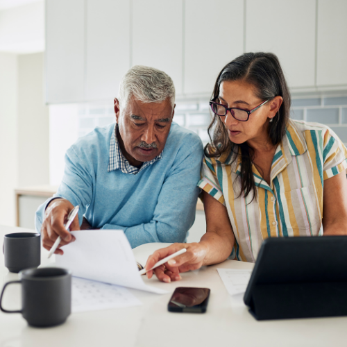 An older couple reviewing their household finances together